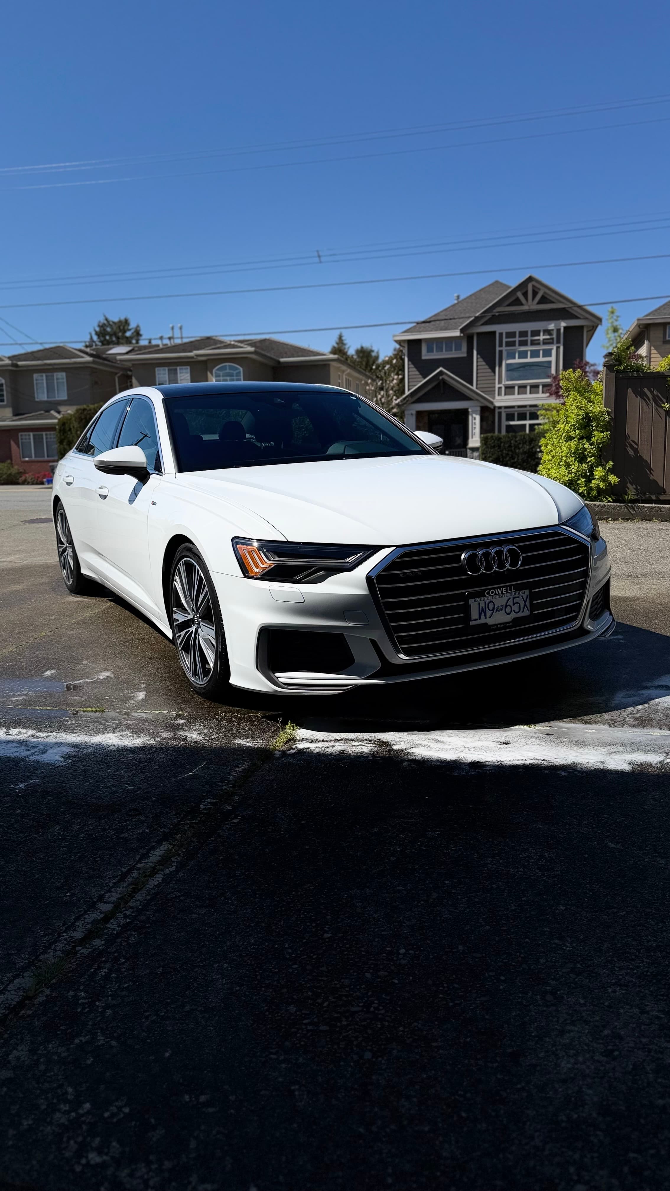 Freshly washed white Audi A6 on a sunny Pitt Meadows street — mobile car detailing