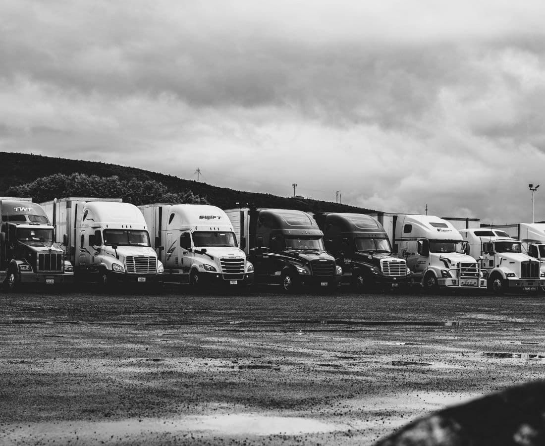 Row of commercial semi trucks parked in Vancouver fleet yard