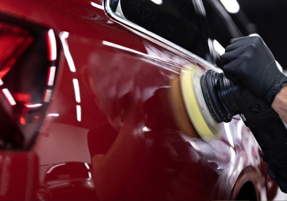 Swirl removal with a dual-action polisher on red paint — professional paint correction Vancouver