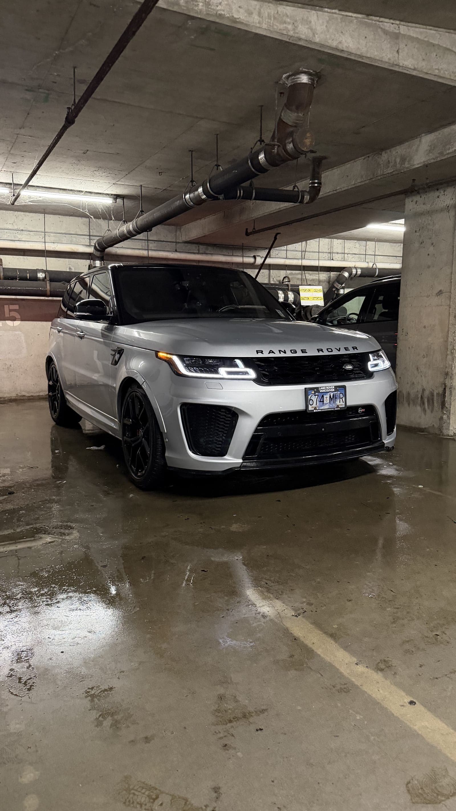 Detailed Range Rover Sport SVR on a wet parkade floor after a Crystal Gloss mobile detail in Vancouver rain